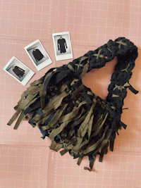 a bag with tassels and photos on top of it